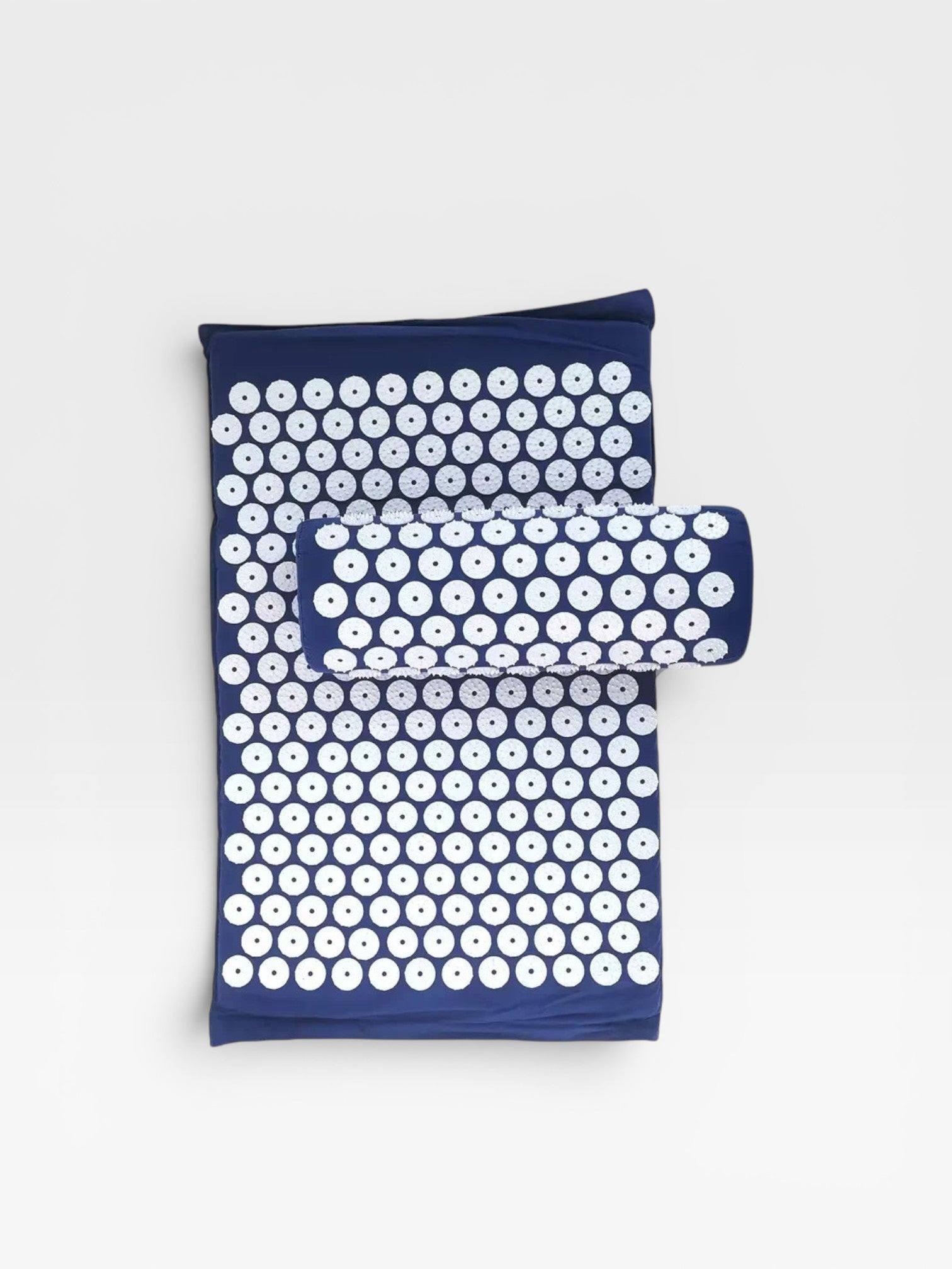 Essential Selects navy blue acupressure mat and pillow set with white ABS plastic spikes for relaxation and relief