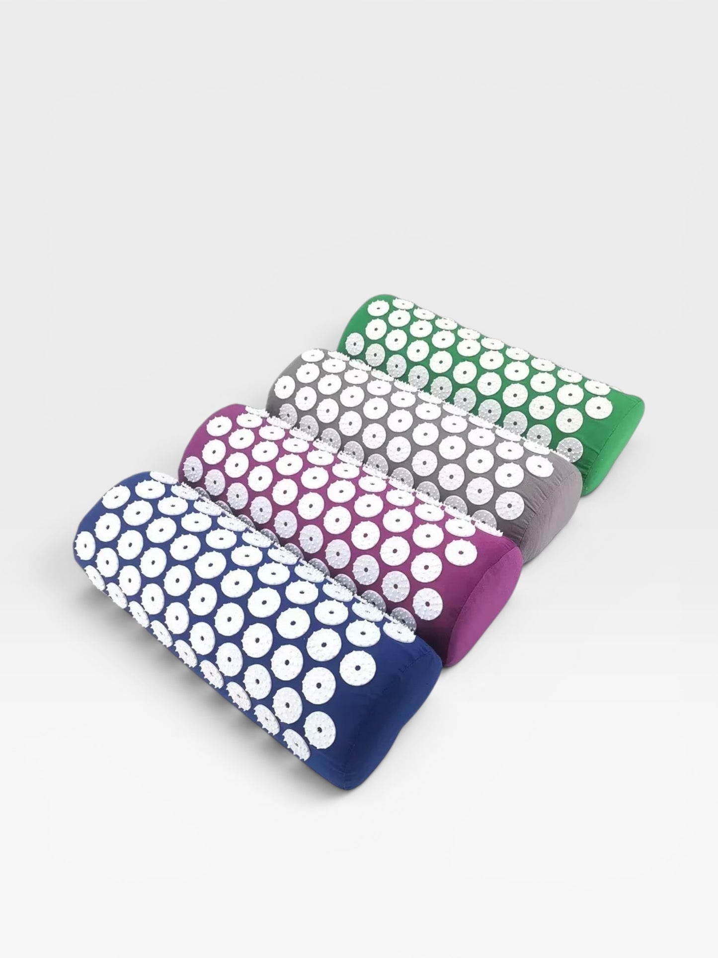 Essential Selects acupressure pillows in blue, purple, grey, and green with white ABS plastic spike discs for relaxation.
