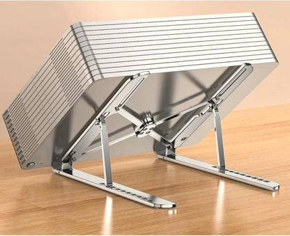 Essential Selects silver adjustable laptop stand with 10-level height settings and foldable metal frame on a desk