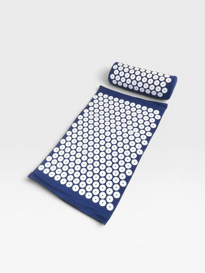 Essential Selects blue acupressure mat and pillow set with white ABS plastic spikes for relaxation and pain relief.