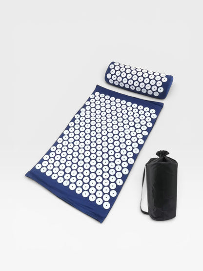 Essential Selects blue acupressure mat and pillow set with white ABS plastic spikes and a black carrying bag.