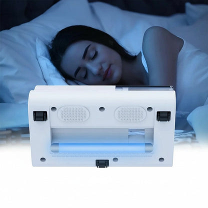 Essential Selects cordless mattress vacuum with UV light cleaning a bed while a woman sleeps in the background