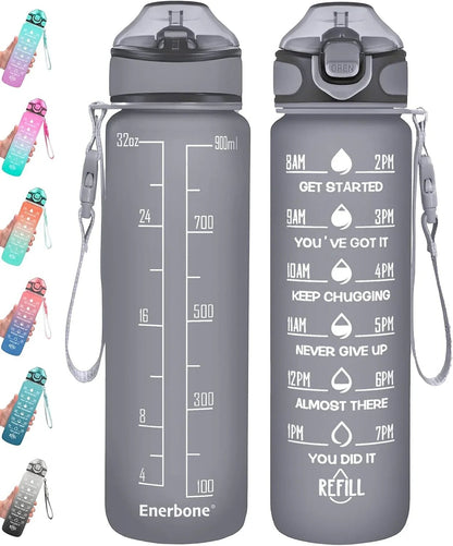Essential Selects Enerbone 32oz frosted motivational water bottle with time markers, straw, and carry strap in grey.