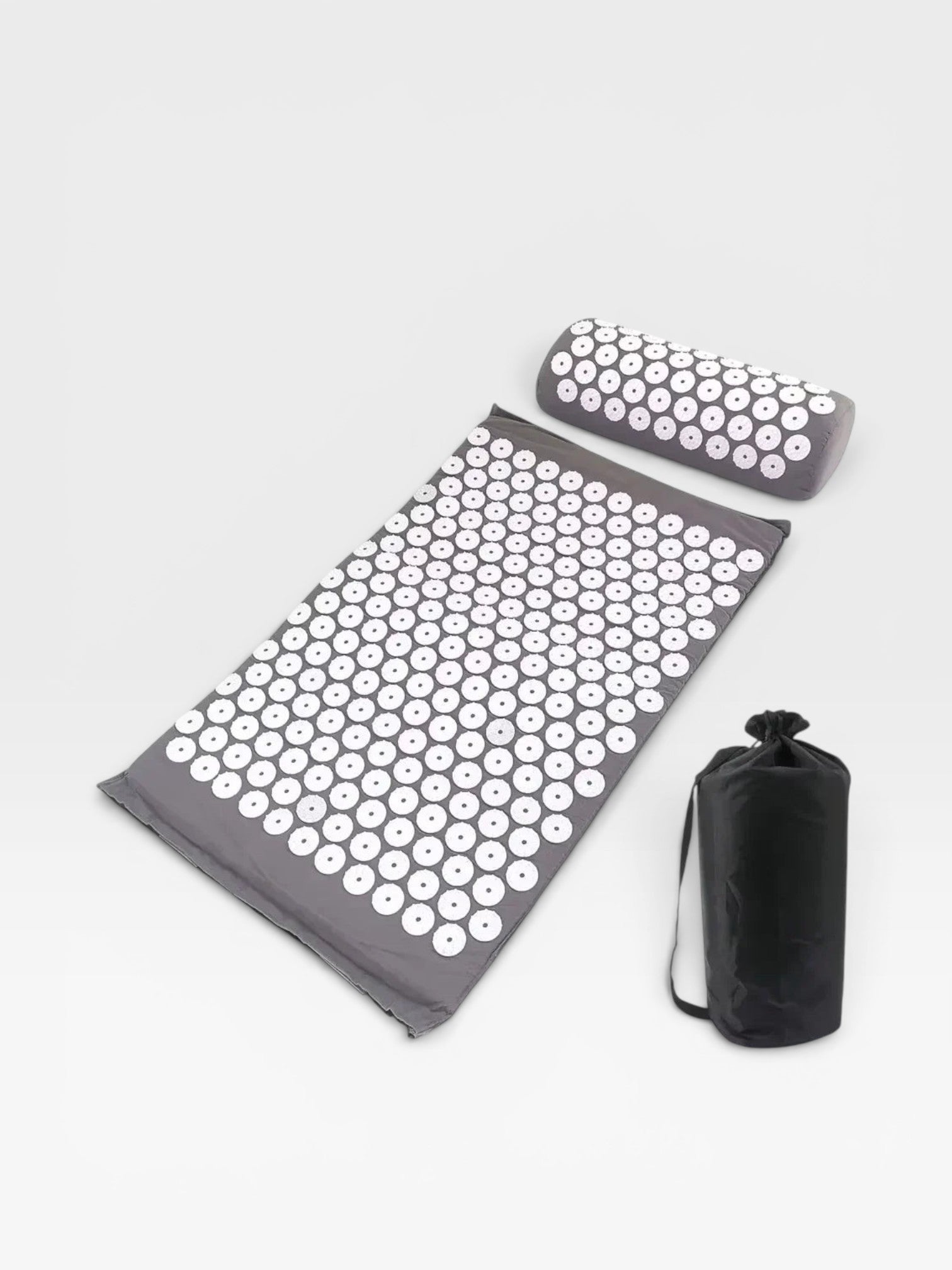 Essential Selects grey acupressure mat and pillow set with white ABS plastic spikes and a black carrying bag.