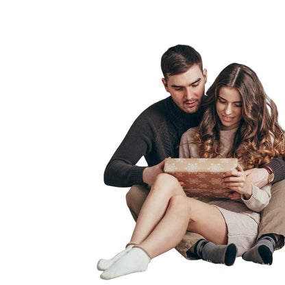 Essential Selects muscle massage roller stick being gifted by a couple in a cozy holiday living room setting