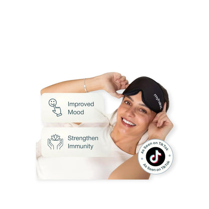 Essential Selects MyHalos 3D contoured black sleep mask worn by a smiling woman for complete light blocking