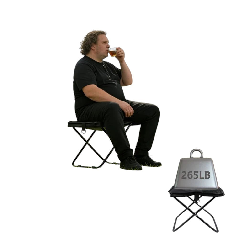 Essential Selects portable black folding stool with aluminum frame, supporting 265 lbs, used in a park setting.