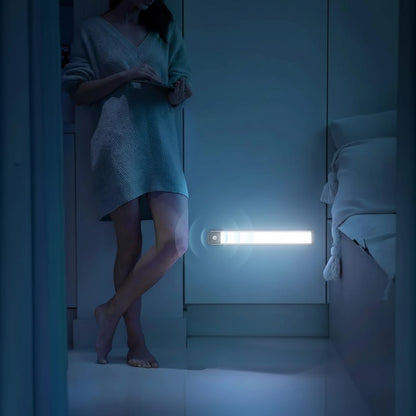 Essential Selects rechargeable motion sensor LED light mounted on a bedroom wall, providing bright white illumination.