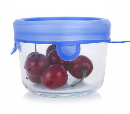 Essential Selects blue silicone stretch lid sealing a small glass bowl filled with fresh red cherries