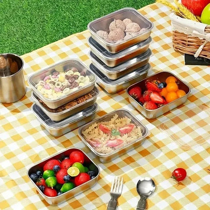 Essential Selects 5-piece stainless steel stackable meal prep containers filled with fresh food on a picnic blanket.