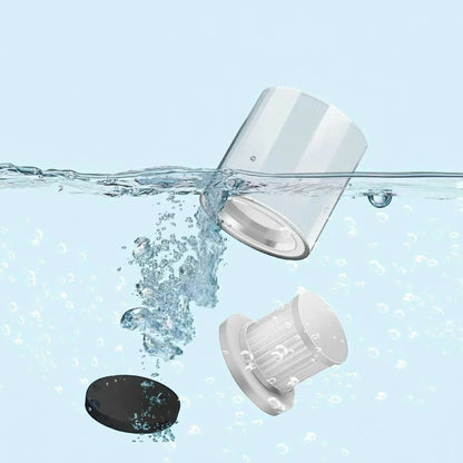 Essential Selects cordless mattress vacuum washable dust bin and HEPA filter components submerged in water for cleaning