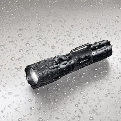 Essential Selects METII waterproof aluminum tactical flashlight with adjustable focus and belt clip in the rain.
