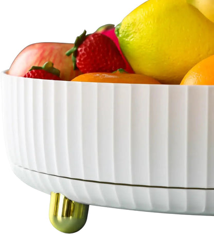 Essential Selects white rotating storage tray filled with fresh fruit, featuring a ribbed design and gold feet.