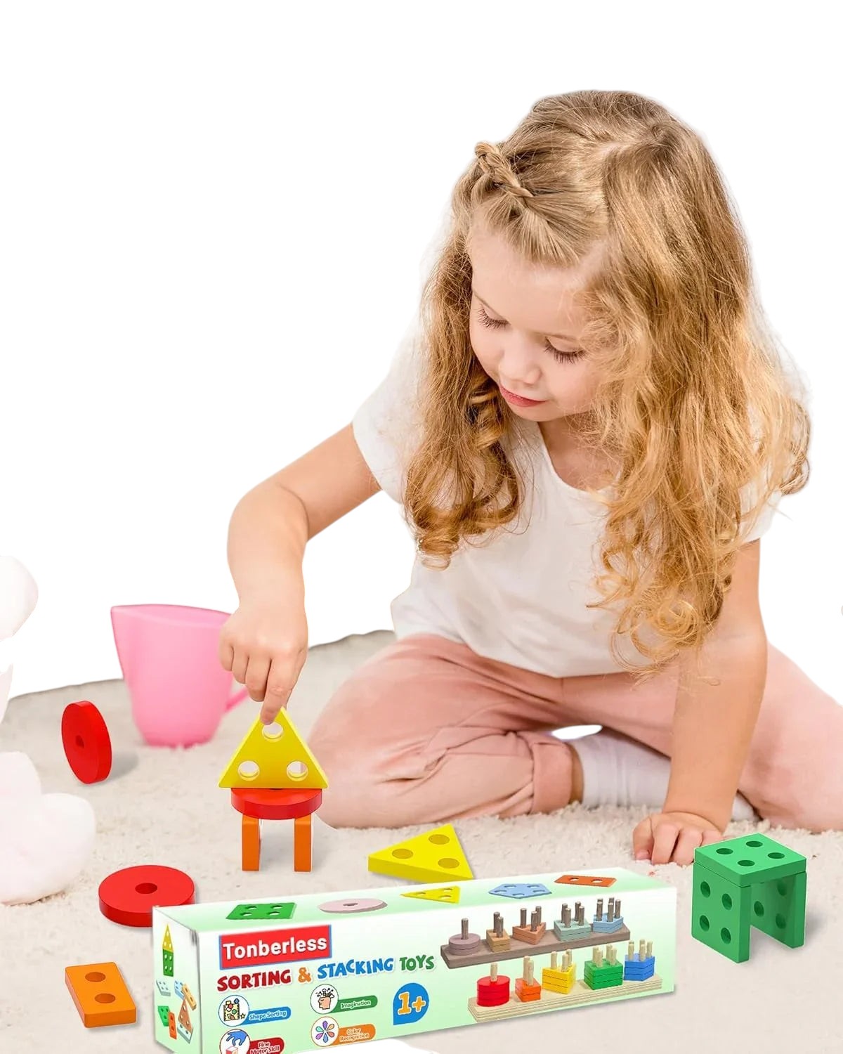 Essential Selects wooden Montessori shape sorting and stacking toy being played with by a young girl on a rug