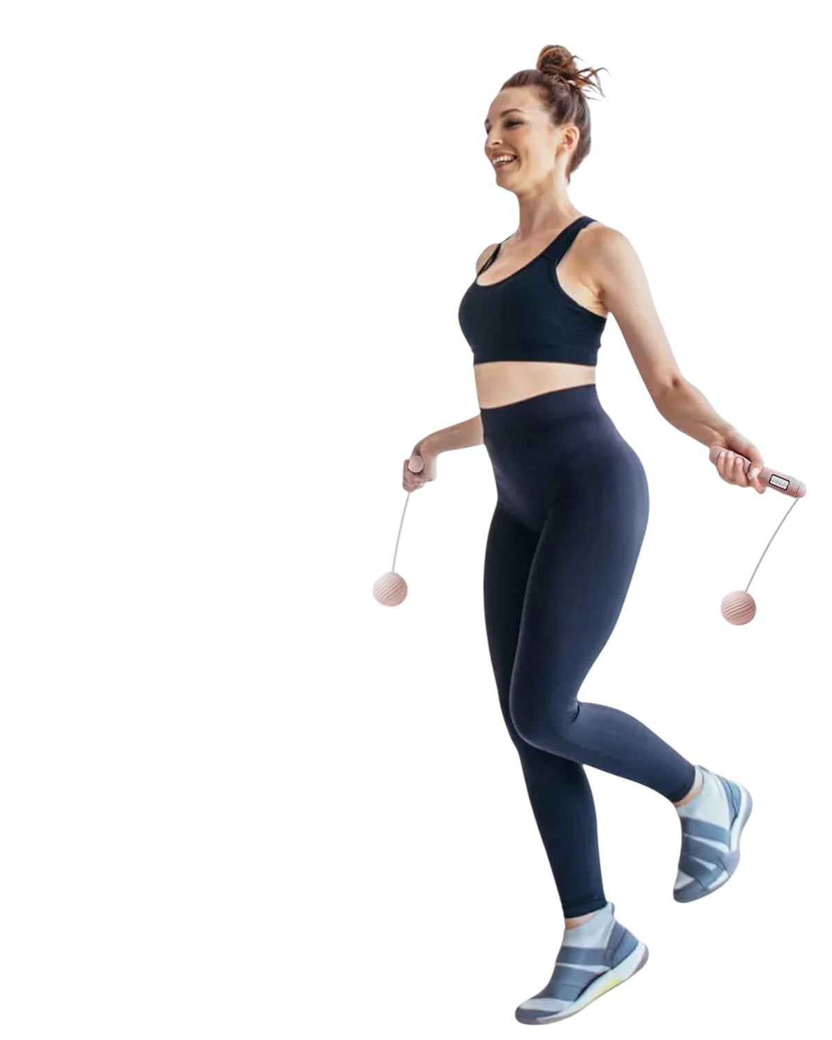 Essential Selects YOTTOY pink cordless jump rope with LED counter being used by a woman in a home workout setting